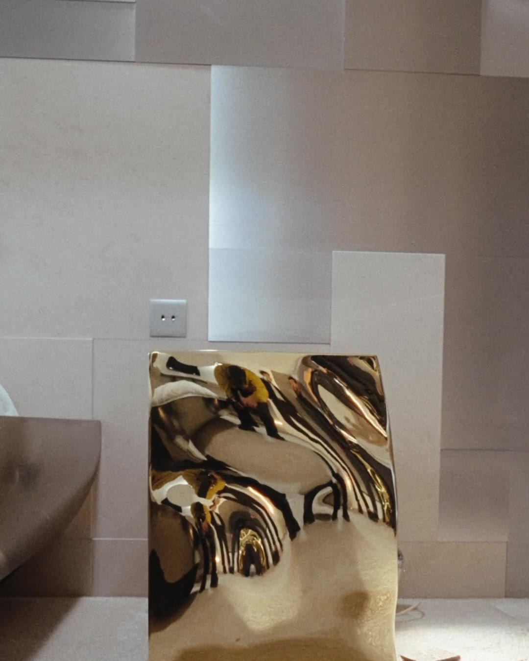 A polished brass piece in a stone interior