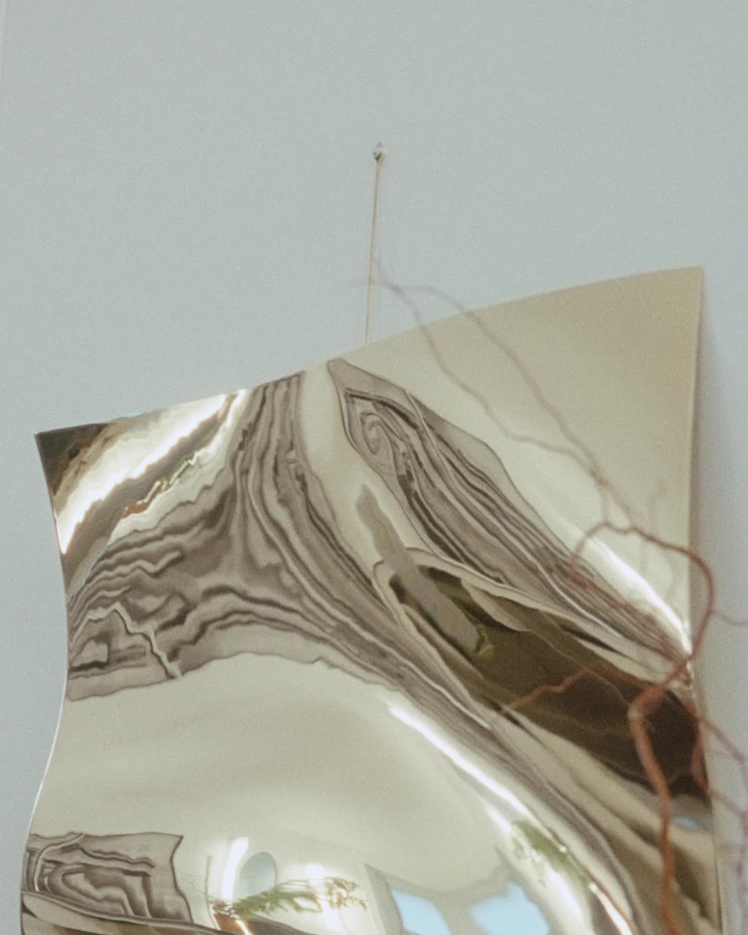 A brass wall piece, draped like fabric