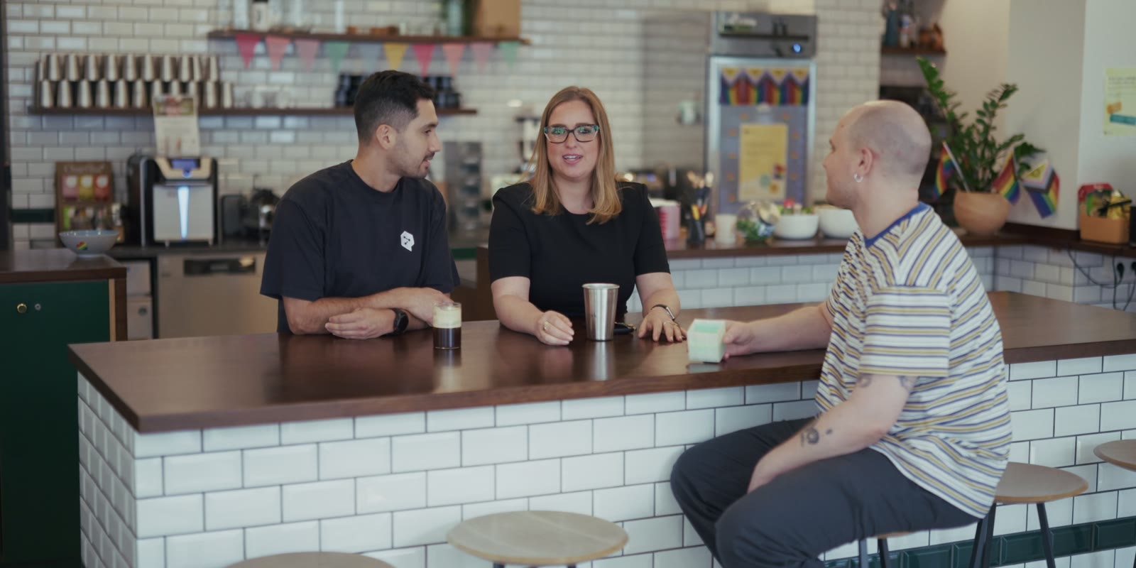 Three colleagues at the office coffee bar