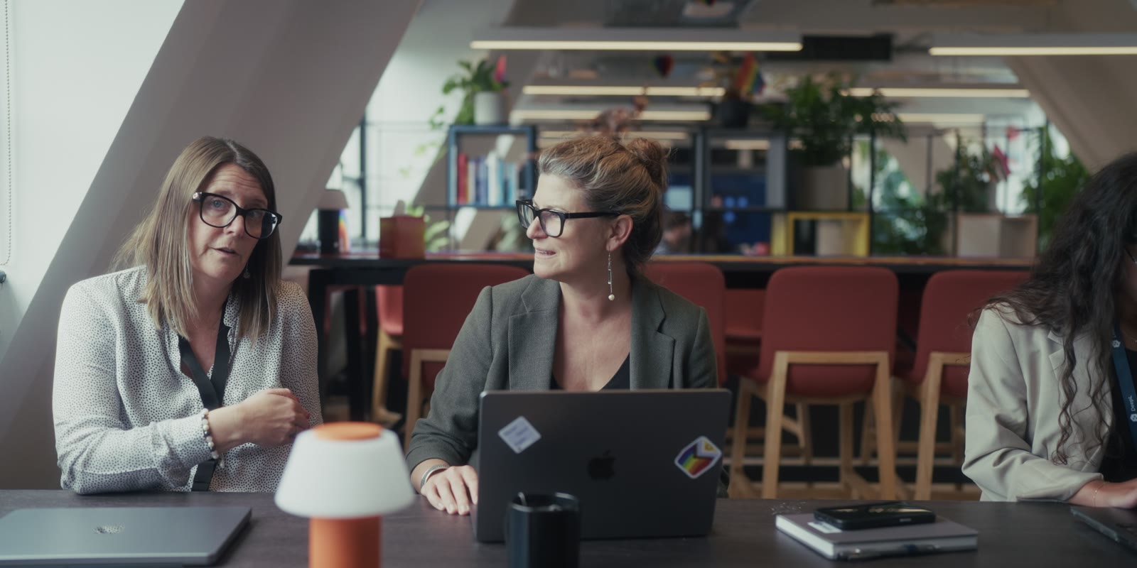Two colleagues at work around a table