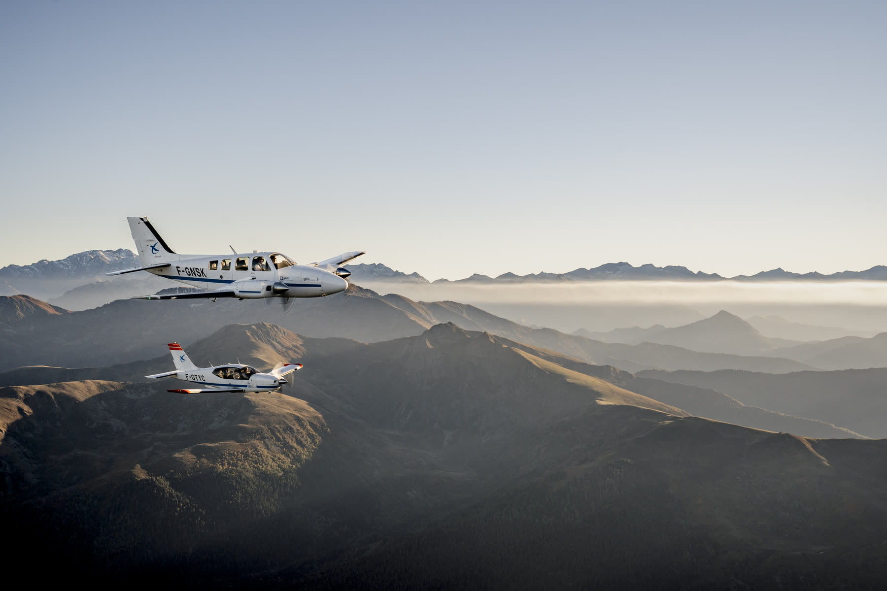 Two aircraft above a sea of cloud