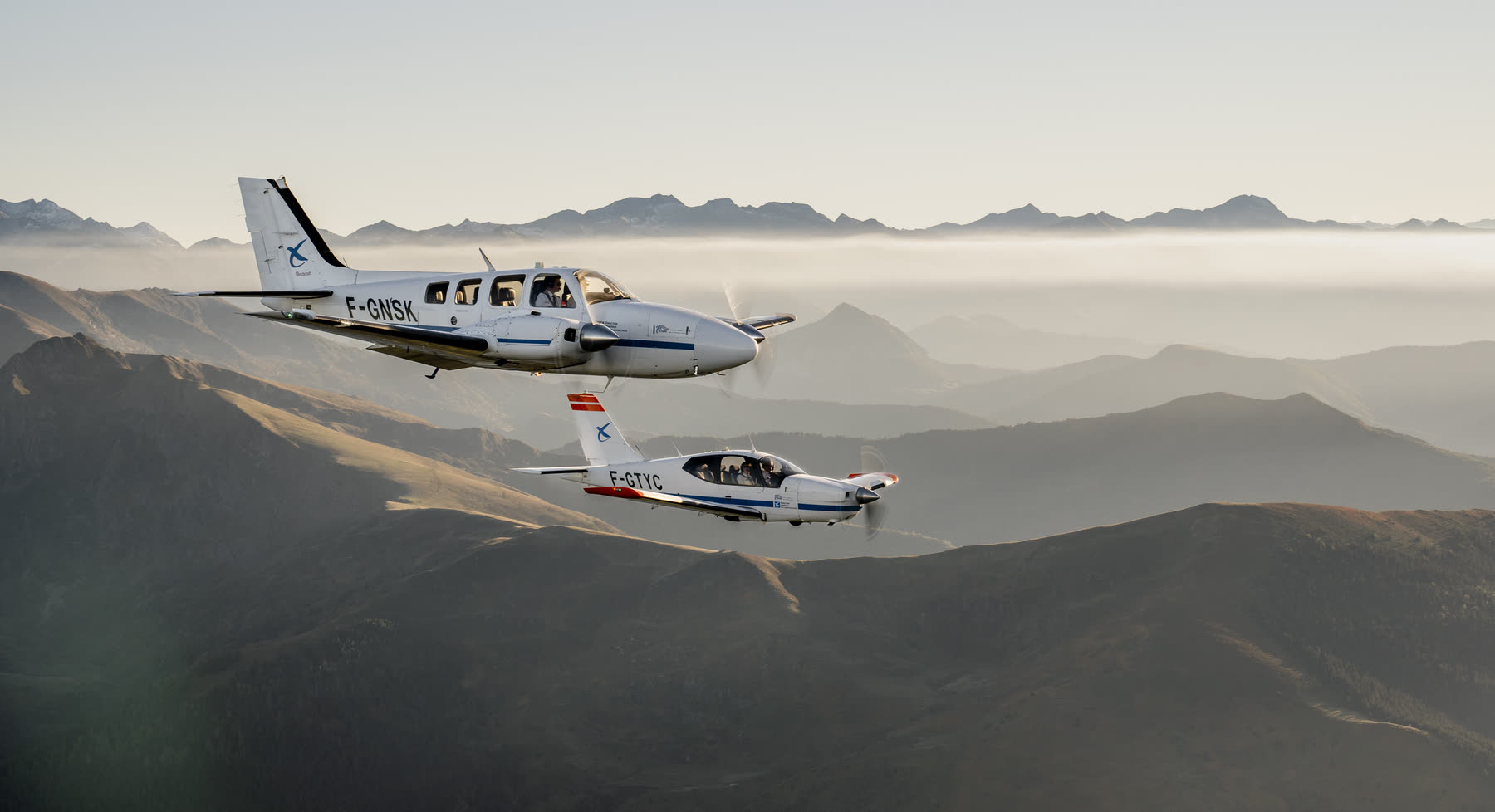 Two aircraft in formation above the haze