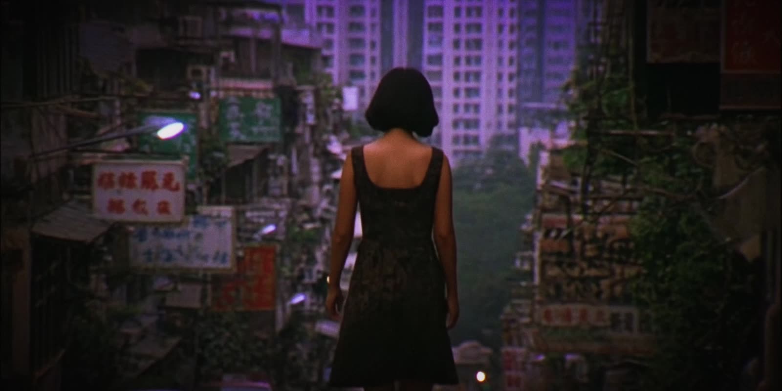 A woman alone in a narrow street full of signs